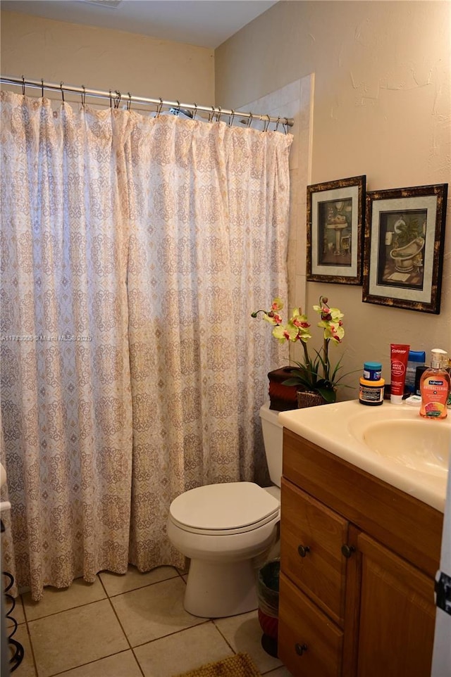 full bathroom featuring tile patterned flooring, toilet, and vanity