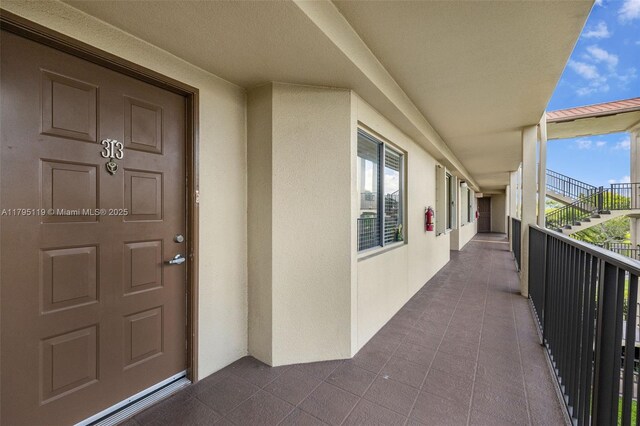 1351 SW 141st Ave Unit 313G, Pembroke Pines, FL 33027 - view of exterior entry featuring stucco siding and a balcony