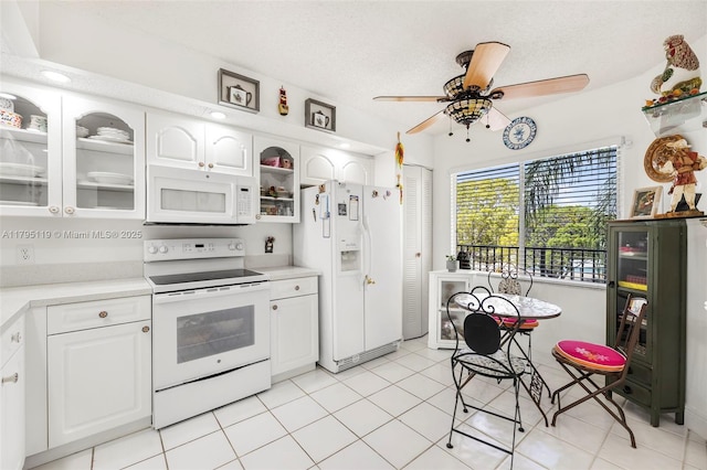 kitchen with light countertops, a ceiling fan, white appliances, and glass insert cabinets