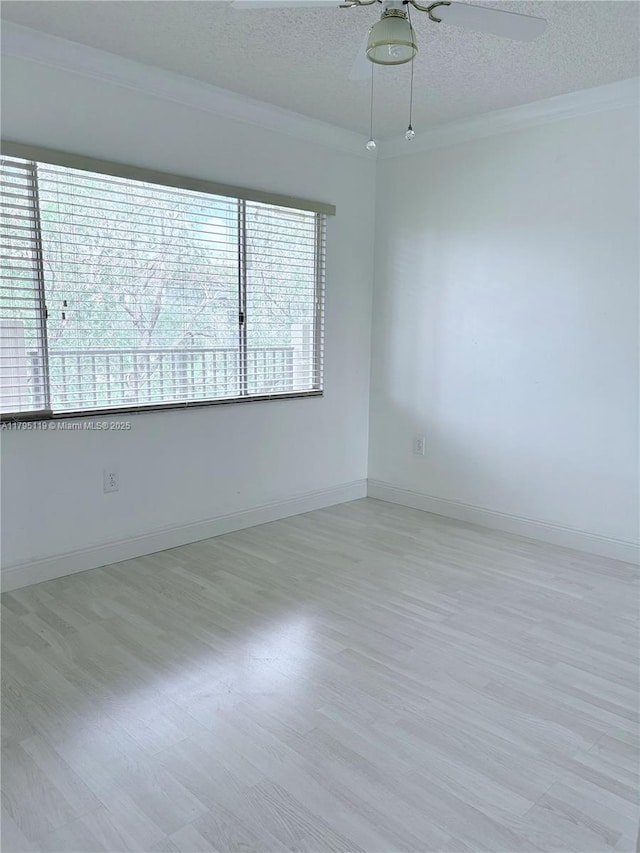 1351 SW 141st Ave Unit 313G, Pembroke Pines, FL 33027 - empty room featuring wood finished floors, a textured ceiling, crown molding, a ceiling fan, and baseboards