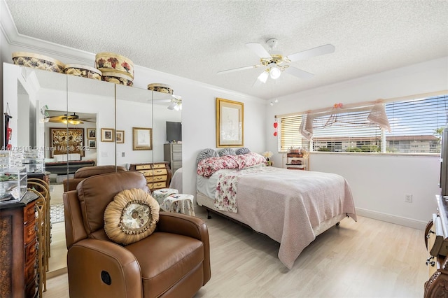 bedroom with light wood-style flooring, a closet, and a textured ceiling