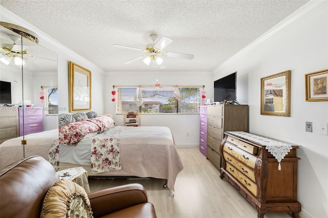 bedroom featuring crown molding, a textured ceiling, multiple windows, and light wood-type flooring