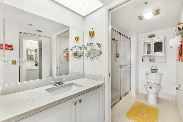 1351 SW 141st Ave Unit 313G, Pembroke Pines, FL 33027 - bathroom featuring a shower stall, toilet, vanity, and tile patterned floors
