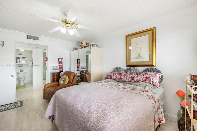 bedroom with visible vents, a textured ceiling, light wood-style flooring, and crown molding