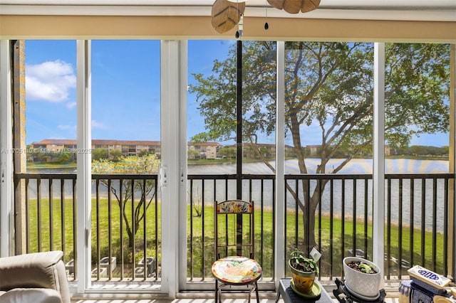 sunroom / solarium with a water view and a wealth of natural light