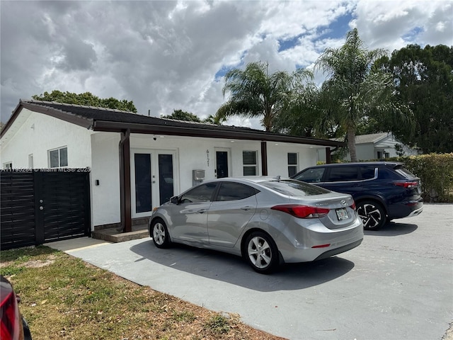 6121 Coral Way, Miami, FL 33155 - exterior space with stucco siding, french doors, and fence