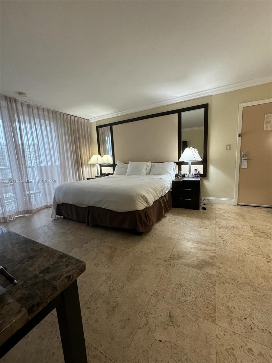 19201 Collins Ave Unit 831, Sunny Isles Beach, FL 33160 - bedroom with crown molding and baseboards