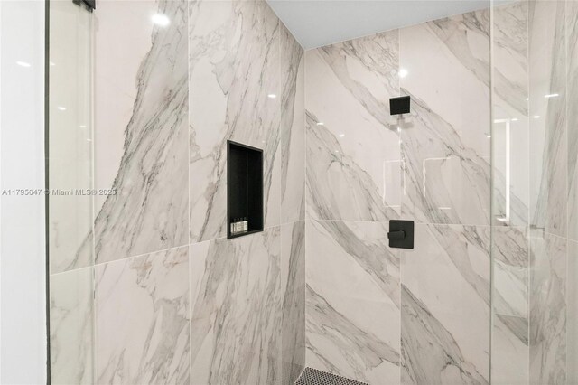 bathroom with a marble finish shower