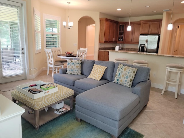 1080 SW Southlakes Way SW, Vero Beach, FL 32968 - living area featuring light tile patterned floors, arched walkways, baseboards, and recessed lighting