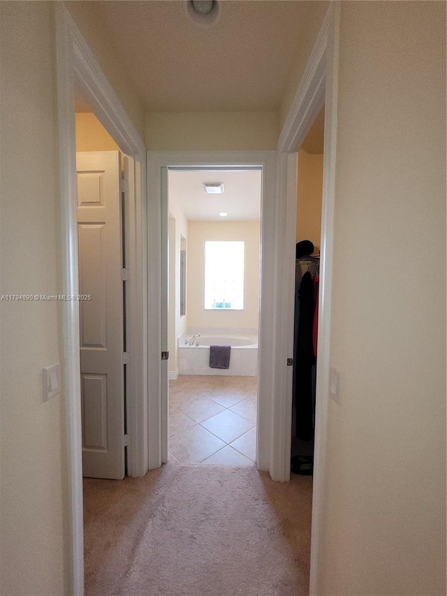 1080 SW Southlakes Way SW, Vero Beach, FL 32968 - corridor with visible vents, light tile patterned floors, and light carpet