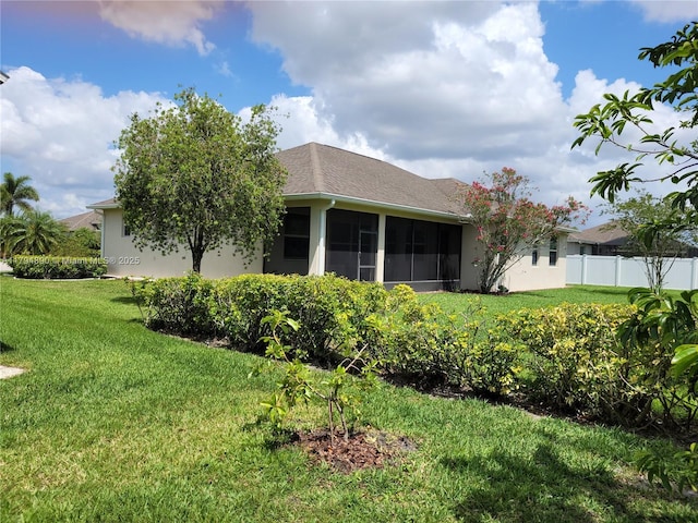 1080 SW Southlakes Way SW, Vero Beach, FL 32968 - back of house featuring a lawn, fence, and a sunroom