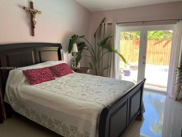 bedroom featuring access to outside and french doors