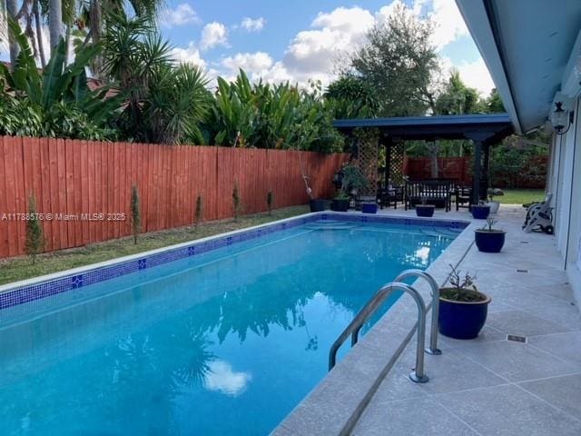 view of pool featuring a patio, a fenced backyard, and a fenced in pool