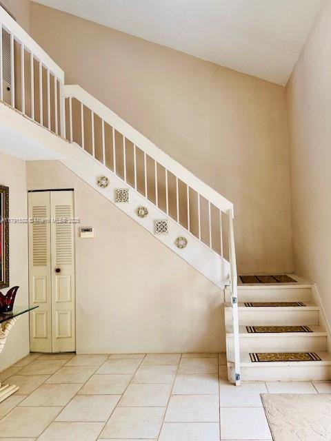 stairway featuring tile patterned flooring
