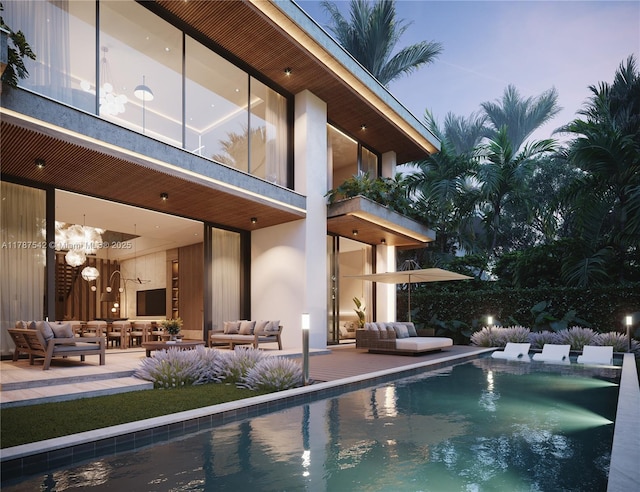 view of swimming pool with an outdoor living space, a patio area, and a fenced in pool