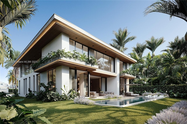 rear view of property featuring a lawn, a balcony, an outdoor hangout area, a patio, and stucco siding