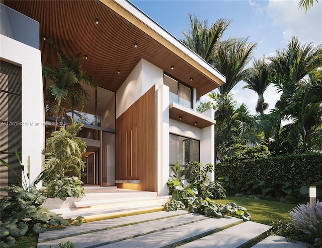 entrance to property featuring stucco siding