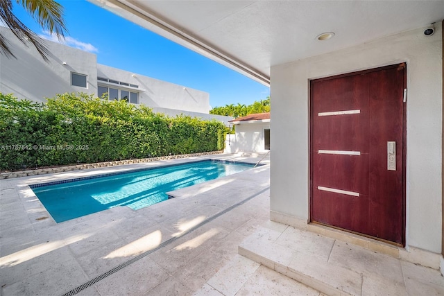 view of swimming pool with a patio and a fenced in pool