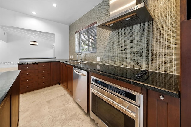 kitchen with backsplash, appliances with stainless steel finishes, range hood, a sink, and dark stone counters