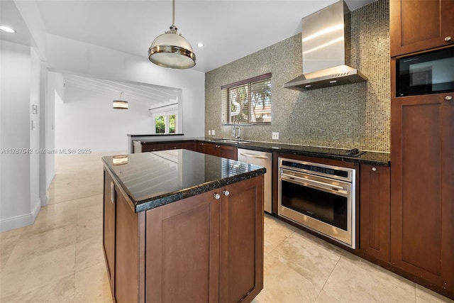 kitchen with wall chimney range hood, a kitchen island, tasteful backsplash, a sink, and black appliances