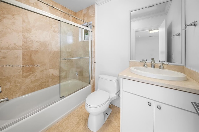bathroom featuring toilet, combined bath / shower with glass door, and vanity