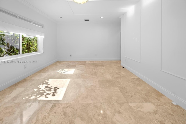 unfurnished room with baseboards, ornamental molding, and visible vents