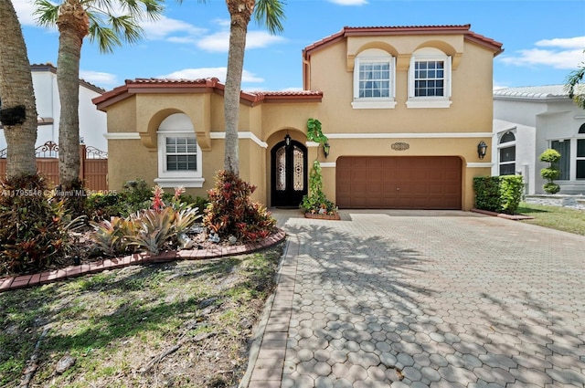 15870 NW 10th St, Pembroke Pines, FL 33028 - mediterranean / spanish-style house with stucco siding, decorative driveway, an attached garage, and a tile roof