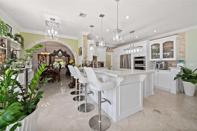 15870 NW 10th St, Pembroke Pines, FL 33028 - kitchen with stainless steel appliances, a chandelier, a peninsula, ornamental molding, and backsplash
