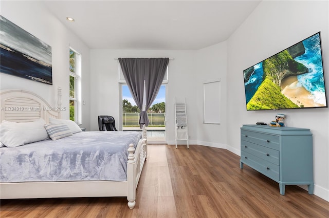 bedroom with baseboards, recessed lighting, and wood finished floors