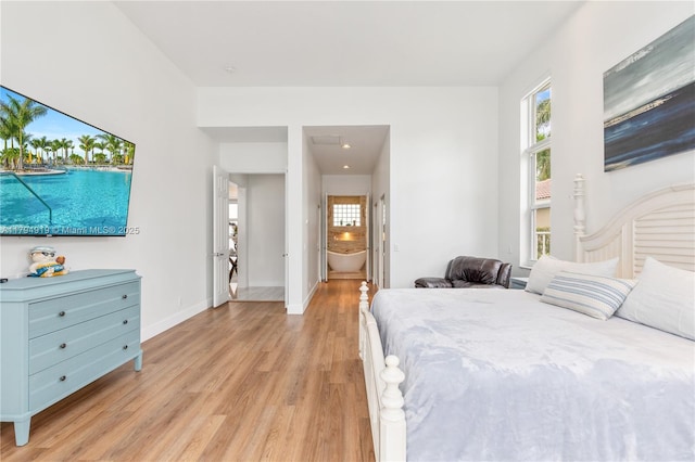 bedroom with baseboards and light wood finished floors