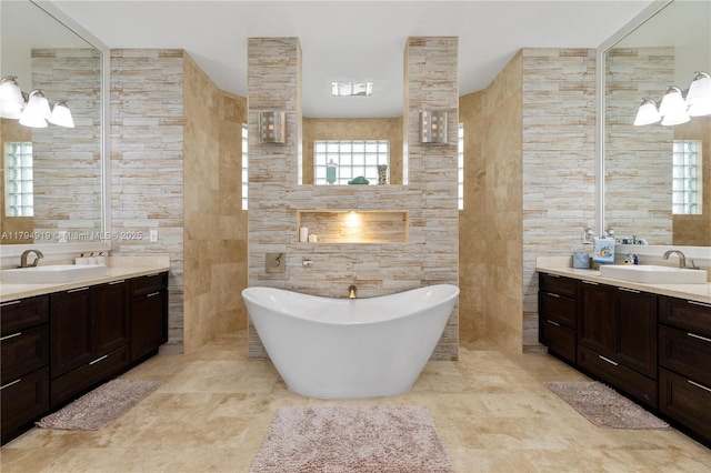 bathroom featuring a sink, two vanities, and tile walls