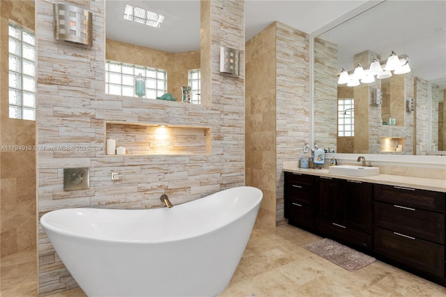 bathroom featuring vanity, tile walls, and a freestanding bath