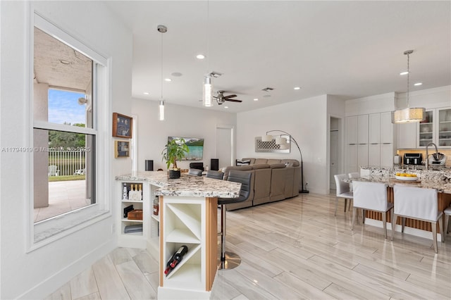 kitchen with recessed lighting, open shelves, a breakfast bar area, and ceiling fan