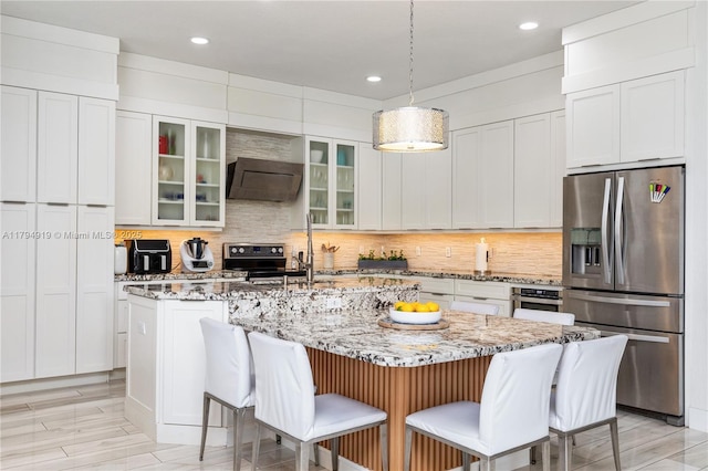 kitchen featuring recessed lighting, appliances with stainless steel finishes, backsplash, and extractor fan