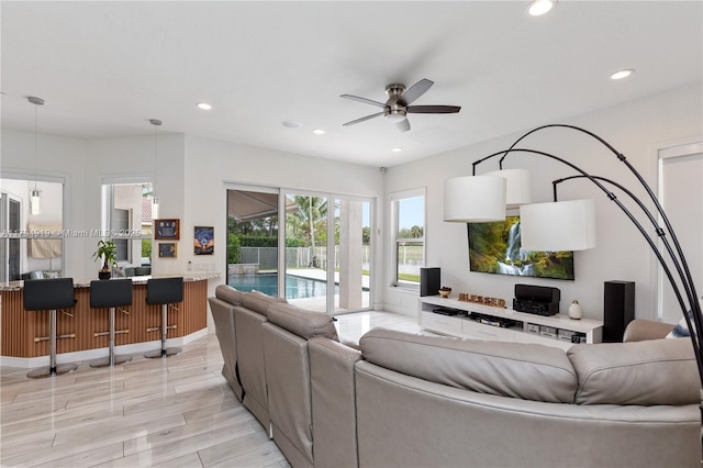 living area with recessed lighting and a ceiling fan