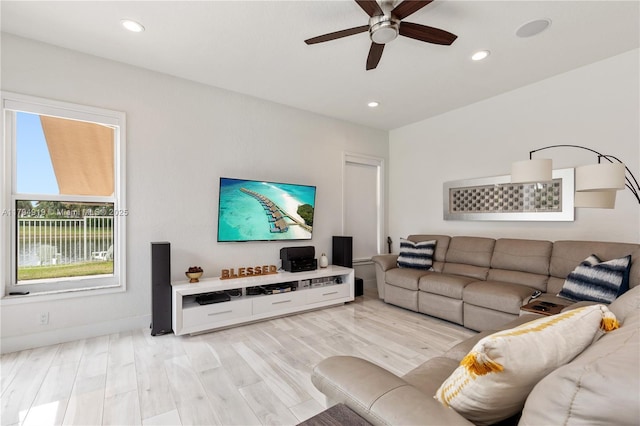 living room featuring a ceiling fan, recessed lighting, and light wood finished floors