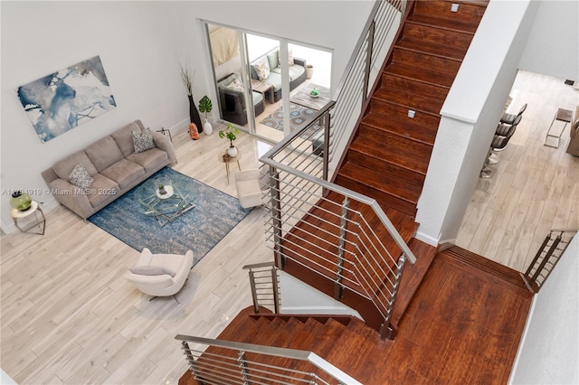 staircase featuring baseboards and wood finished floors