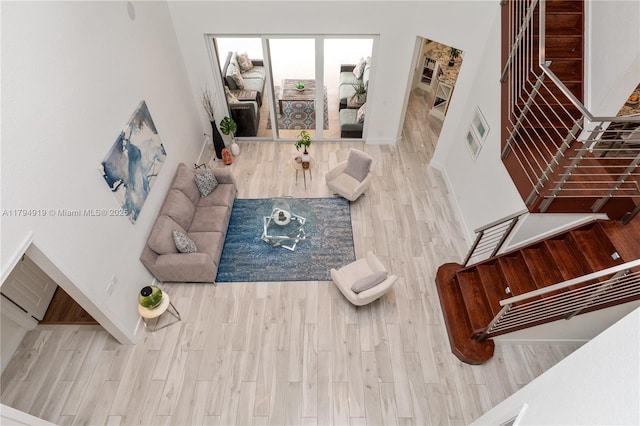living area featuring baseboards and wood finished floors