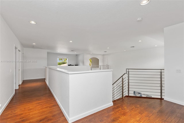 hall featuring recessed lighting, an upstairs landing, and wood finished floors