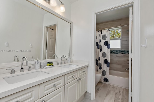 full bathroom featuring double vanity, toilet, a sink, and shower / bath combo