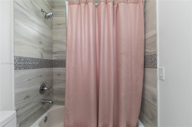full bathroom with shower / bath combination with curtain and toilet