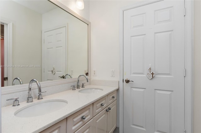 full bathroom with a sink and double vanity