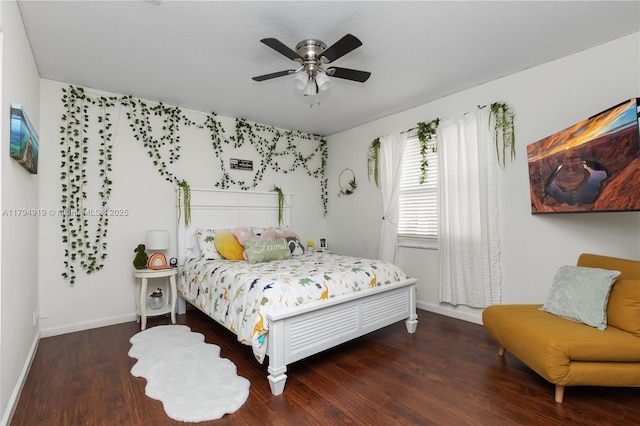 bedroom with baseboards, ceiling fan, and wood finished floors