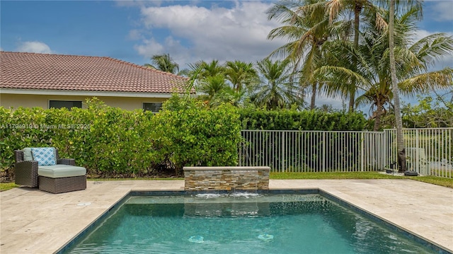 view of swimming pool with fence, a fenced in pool, and a patio area