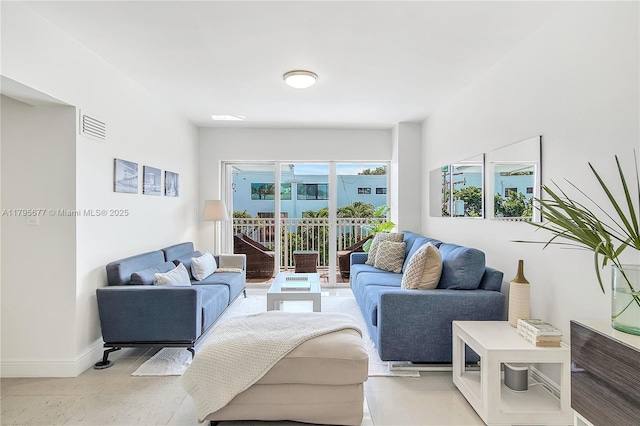 living room featuring baseboards, visible vents, and light tile patterned floors