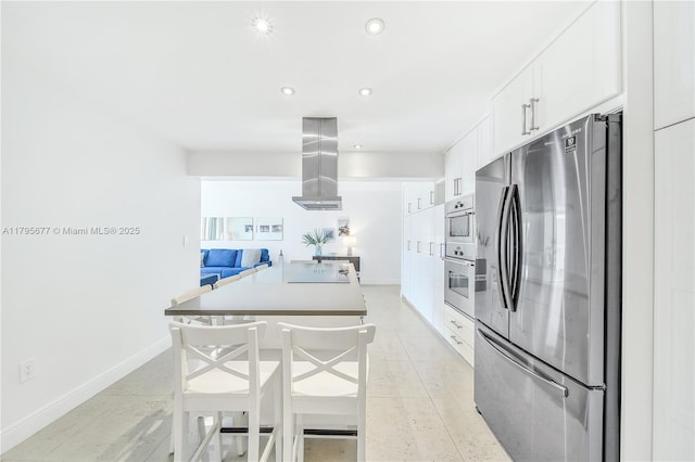 kitchen featuring exhaust hood, white cabinets, stainless steel appliances, recessed lighting, and baseboards