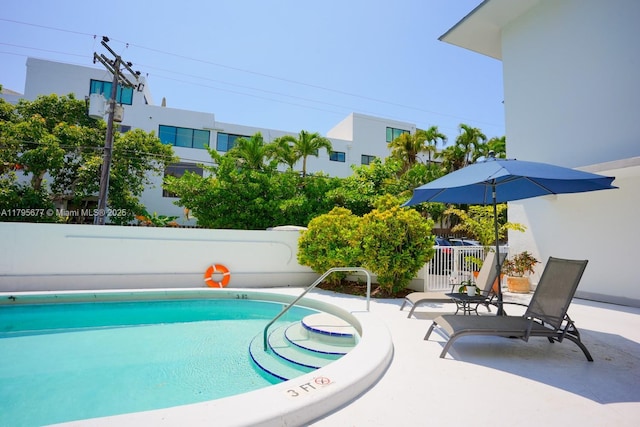 pool featuring a patio and fence