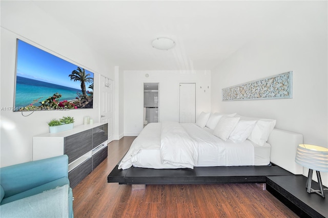 bedroom featuring baseboards and wood finished floors