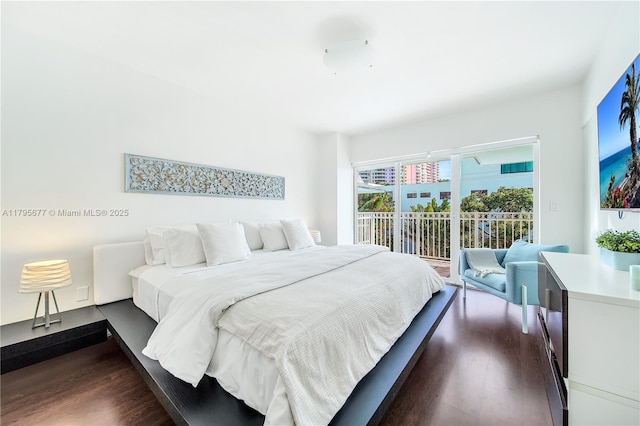 bedroom featuring dark wood-style floors and access to exterior