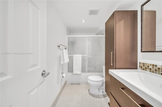 full bathroom featuring vanity, toilet, baseboards, combined bath / shower with glass door, and visible vents